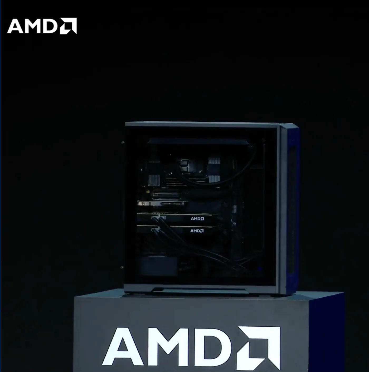 The Threadripper Halo Station on a plinth at AMD's IFA 2026 keynote: a tower workstation with a tempered glass side panel, its interior lit, standing on a branded display block.