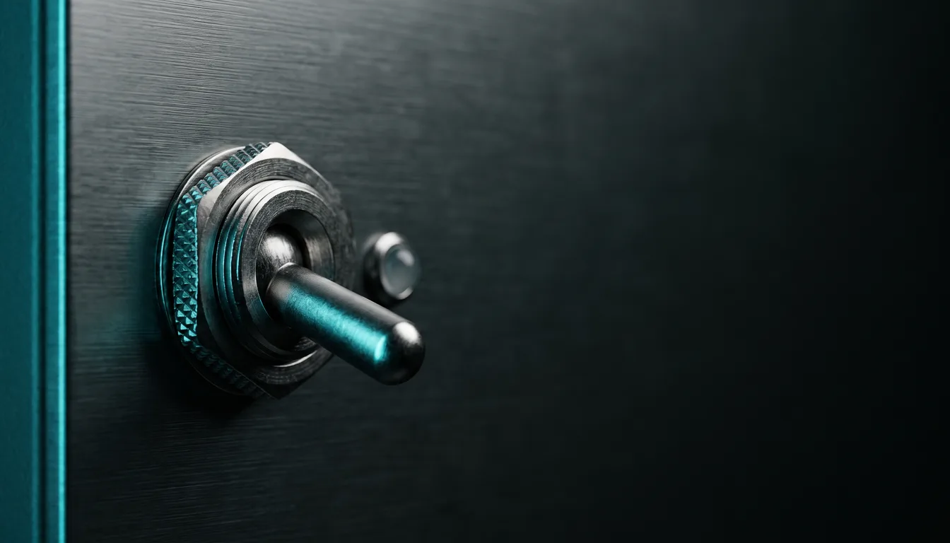 An industrial toggle switch with a knurled metal bezel set into a dark brushed panel, thrown to one side, macro close-up, with a small unlit indicator pin beside it and a cyan edge light down the left of the panel.