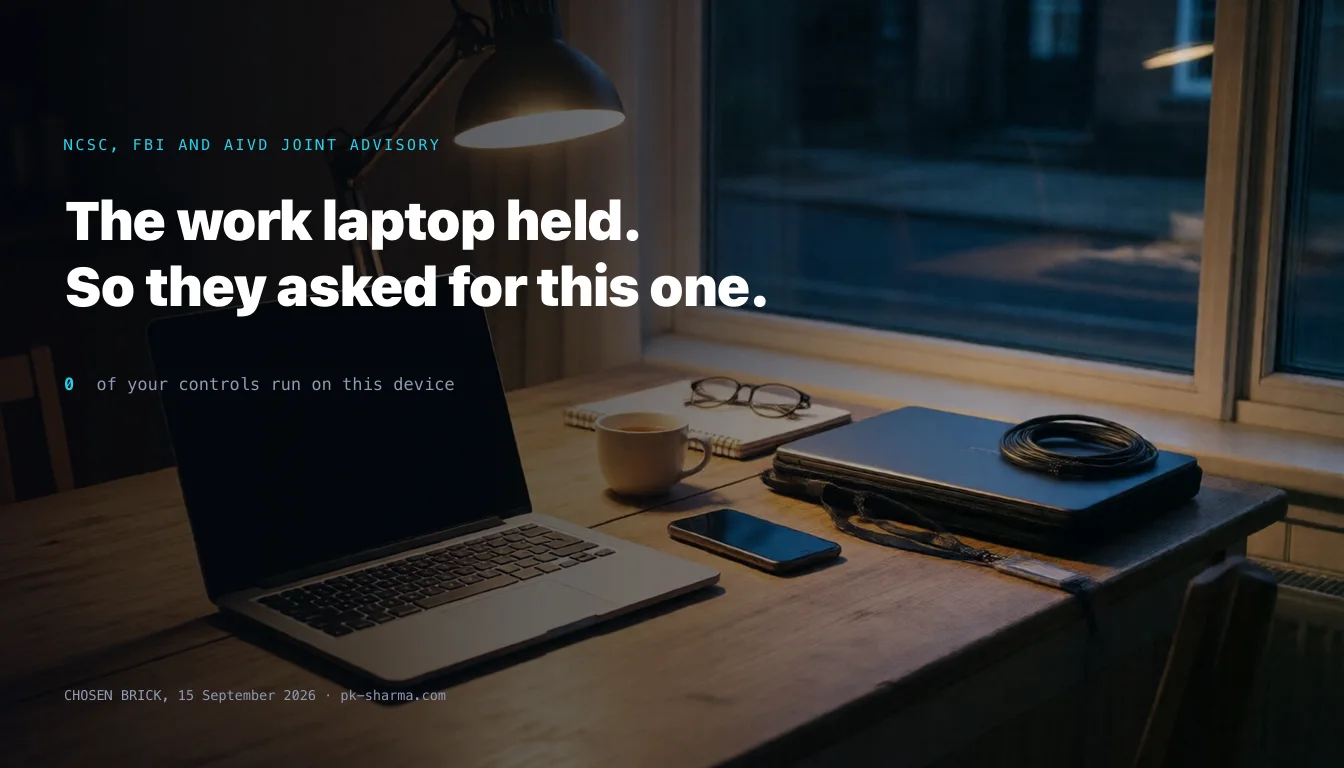 A kitchen table at night used as a desk: an open personal laptop with a dark screen lit by a single warm lamp, a phone face up beside it, and at the far edge in cold light a closed corporate laptop in a sleeve with a coiled security cable and a lanyard.