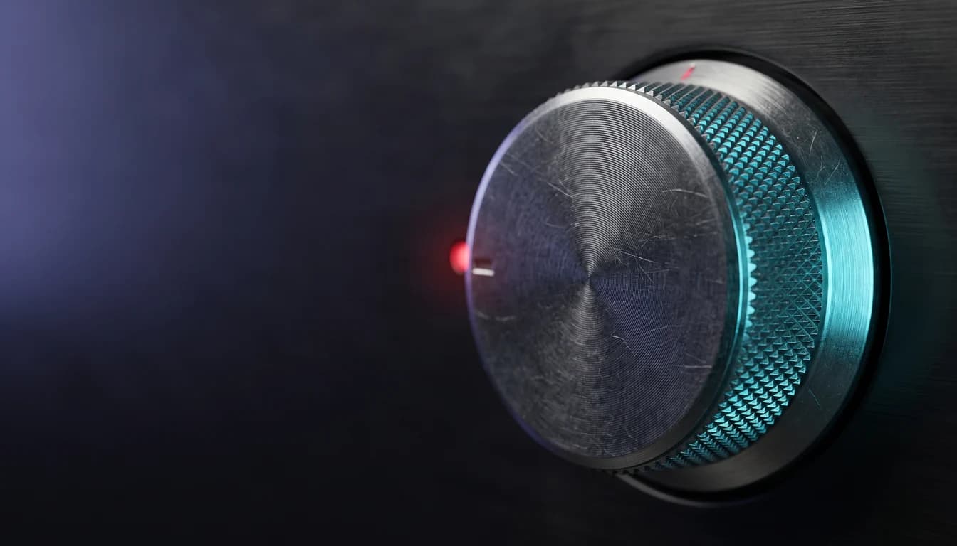 A knurled metal control dial on a dark instrument panel, turned hard over against its end stop, ringed in cyan light with a single red indicator lit beside it.