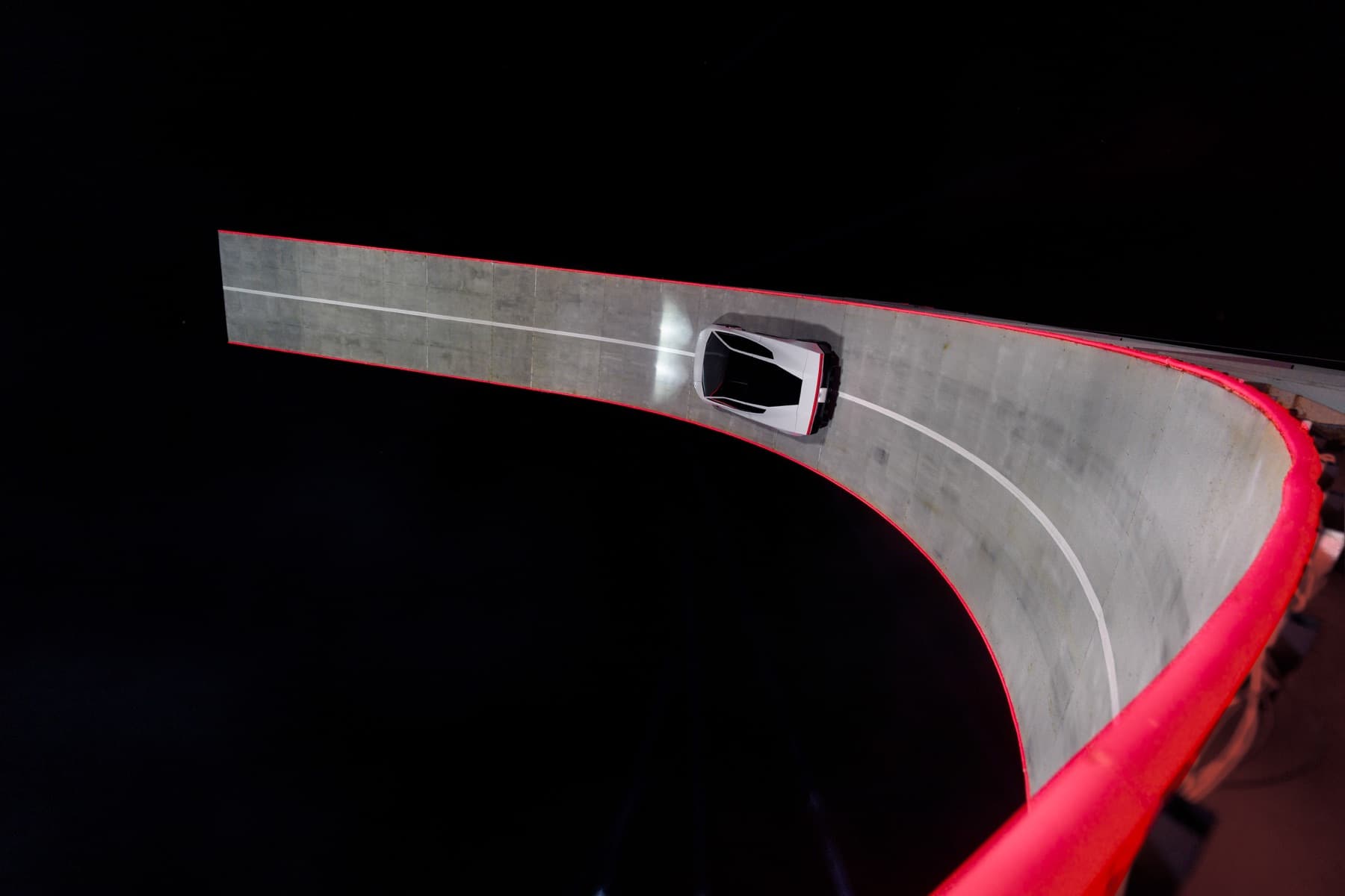 Overhead photograph of the Roadster on the steep curved track.